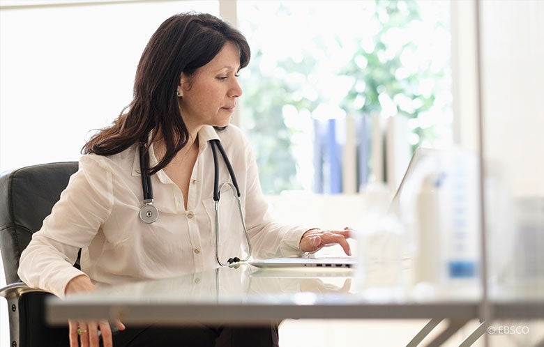 Female Doctor Laptop Desk Plant Books Blog Image    