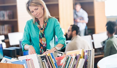 core collections overview librarian cart putting away books promotional slider    