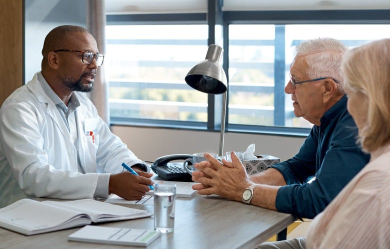 doctor talking senior couple office desk blog image template    